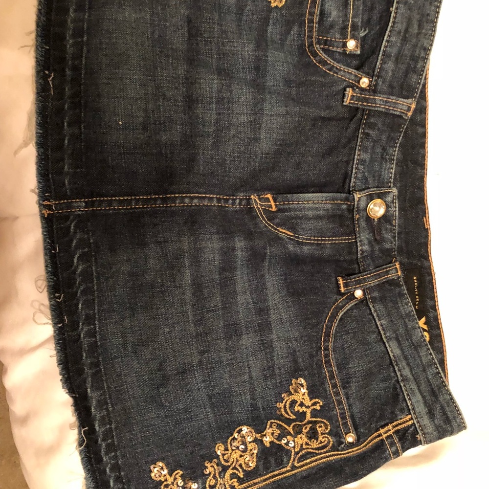 Dark denim mini skirt with gold embellishments